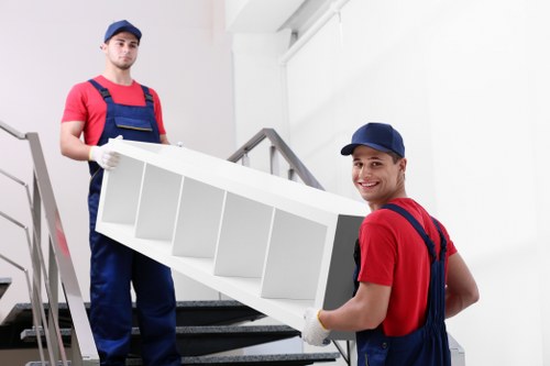 Removal team loading moving equipment for a Balham van service